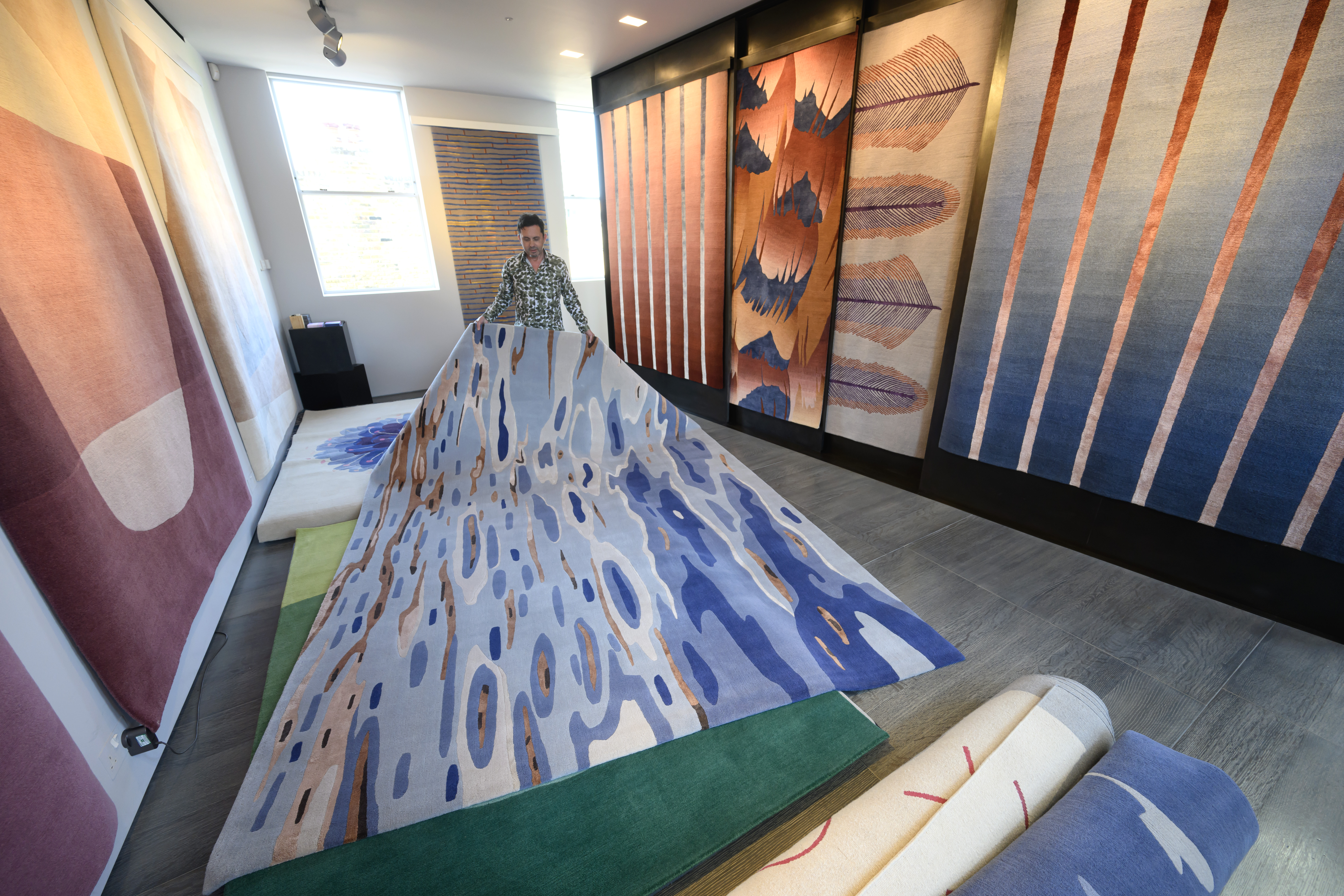 Sales Manager Chris Kane with Deirdre Dyson's GOLDEN GLINTS hand knotted carpet in our London gallery