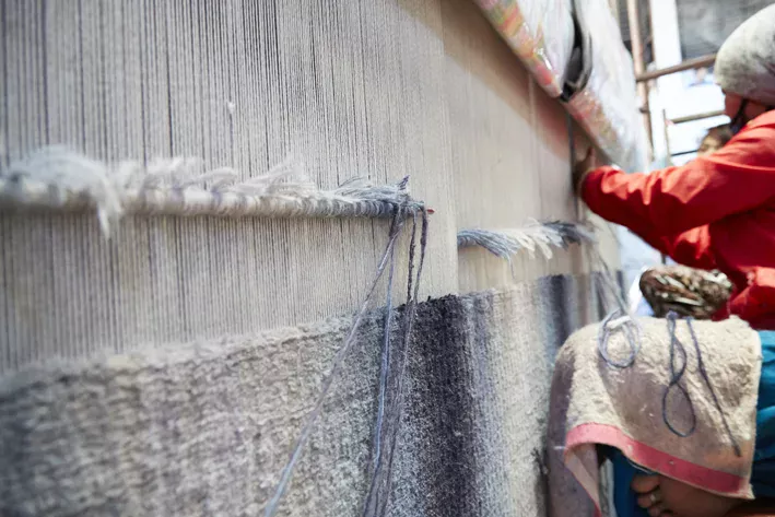 Deirdre Dyson's SEAWASH hand knotted wool carpet on the loom in Nepal